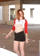 pale redhead poses outdoors