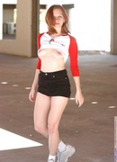 pale redhead poses outdoors